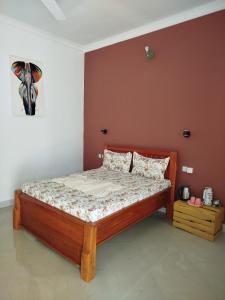 a bedroom with a wooden bed in a room at Fun Haribo B&B Apartment in Uroa