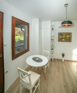 a room with a table and chairs and a window at Plamenatz studio apartments in Virpazar