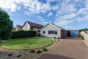 a house with a grassy yard in front of it at 3 Bed in Burnham Market oc-1887 in Burnham Market