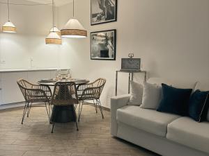 a living room with a couch and a table and chairs at Libeccio - Villa Marina in Marina di Andora
