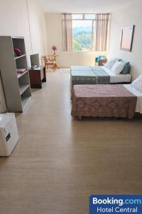 a hotel room with two beds in a room at Hotel Central in Amparo