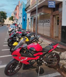 a row of motorcycles parked on the side of a street at Hotel Central in Amparo