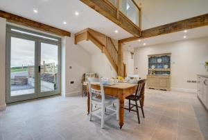 a dining room with a wooden table and chairs at 2 Bed in Bishops Nympton oc-barton in Bishops Nympton