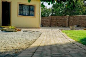 a brick walkway in front of a house at Sunderdale in Gweru