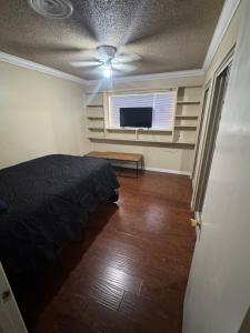 a bedroom with a bed and a flat screen tv at Oldfield in Lancaster
