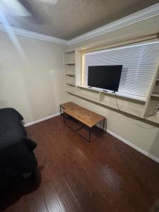 a living room with a tv and a coffee table at Oldfield in Lancaster