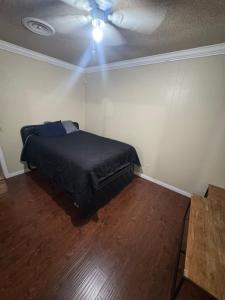 a bedroom with a bed and a ceiling fan at Oldfield in Lancaster