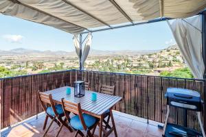 a table and chairs on a balcony with a view at Attic La Mirada - Bonalba Golf in Mutxamel