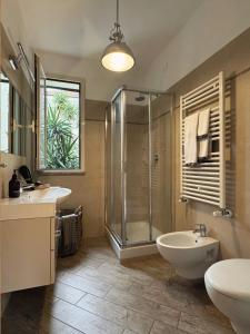a bathroom with a shower and a sink and a toilet at Libeccio - Villa Marina in Marina di Andora +23 photos