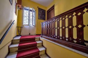a hallway with stairs with a door and a window at Cà Fede in Venice