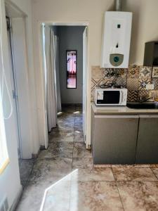 a kitchen with a counter and a microwave on a counter at Depto Civora 3 in Villa Regina