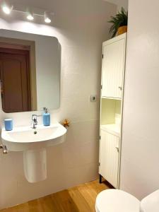 a bathroom with a sink and a mirror at Isla de los Pensamientos in Faro de Cullera +15 photos
