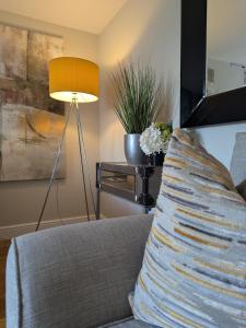 a couch with a pillow on a table with a lamp at Pen-Y-Worlod Cottages in Abergavenny +87 photos