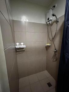 a bathroom with a shower with a shower head at Orwell Heights-Vista Recto in Manila