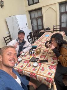 a group of people sitting at a table at Mekhtarin in Bukhara
