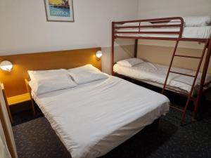 a hotel room with two bunk beds in it at Quick Palace Vannes in Vannes