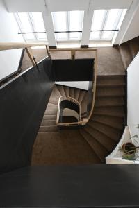 a spiral staircase in a building with windows at Vila Victory polopenze v Krušných horách in Abertamy