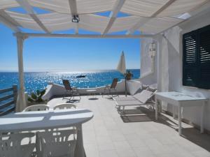 a patio with chairs and a view of the ocean at Villetta Frasena in Santa Maria