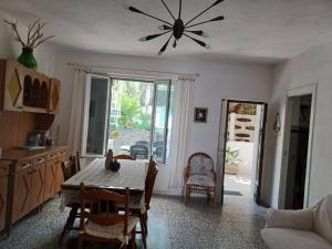 a dining room with a table and a ceiling fan at Villetta Frasena in Santa Maria +18 photos