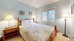 a bedroom with a bed and a lamp and a window at Bluff Condo 4015 in Sun Valley +21 photos