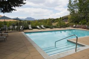 a large swimming pool with chairs and a table at Bluff Condo 4015 in Sun Valley
