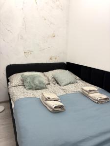 a bed with two pillows on top of it at Apartament Olesno in Olesno