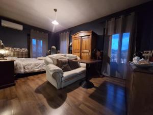 a bedroom with a bed and a chair and a table at Portella delle Fate in Sora
