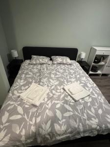 a bed with two pillows and a comforter on it at La Casa de Nido - Mini Studio in Veszprémfajsz
