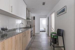 a kitchen with a counter and a chair in it at Coliving San Esteban in La Ñora