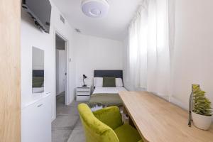 a bedroom with a bed and a table and a couch at Coliving San Esteban in La Ñora