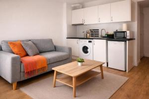 a living room with a couch and a table at Beachfront apartment with sea views in Cunit