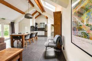 a kitchen and dining room with a table and chairs at De Gemoedelijkheid in Nuenen