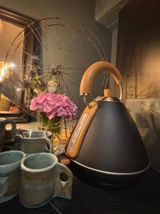 a tea kettle sitting on top of a table at Suite Richovilare - Sauna & Hammam in Riquewihr