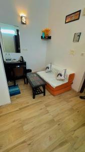 a room with a couch and a table and a mirror at Vrindavan suites omex in Vrindāvan +53 photos