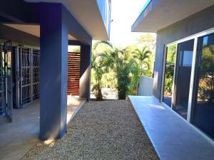a hallway of a house with a courtyard with palm trees at Casa Celeste in Playa Pelada +8 photos