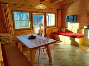 a room with a table and a bed in a cabin at Ebner Casa in Heiligenblut