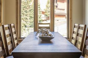 a dining room table with a bowl on top of it at Alpenglow Condo 36A in Big Sky