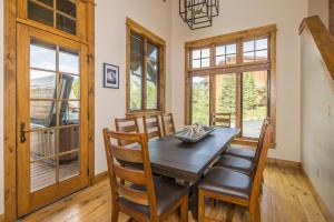 a dining room with a wooden table and chairs at Alpenglow Condo 36A in Big Sky +28 photos