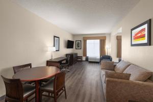 a living room with a couch and a table at Wingate by Wyndham Destin in Destin