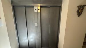 a pair of metal elevator doors in a room at Wilson Hotel in Salta
