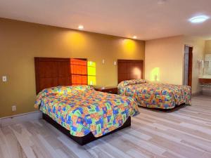 a hotel room with two beds in a room at Aloha Inn McAllen Airport near Medical center Tx in McAllen +56 photos
