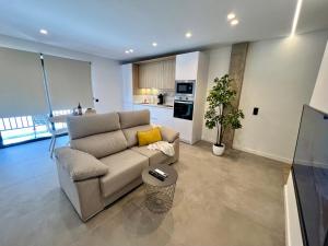 a living room with a couch and a kitchen at La Cala de Alcalá Luxury in Alcalá