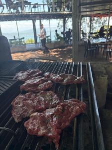 a group of meat cooking on a grill at Bosko cerro verde in Lomas de San Marcelino