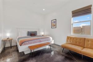 a bedroom with a bed and a window and a couch at Azure Abode at Sand Hollow Resort in Hurricane +66 photos