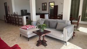 a living room with a couch and a table at Villa Aurora Samaná in Santa Bárbara de Samaná