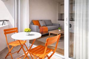 a living room with a table and chairs and a couch at Beachfront apartment with sea views in Cunit