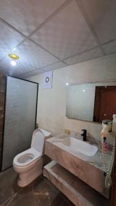 a bathroom with a toilet and a sink at Taj Wadi Rum camp in Wadi Rum +255 photos