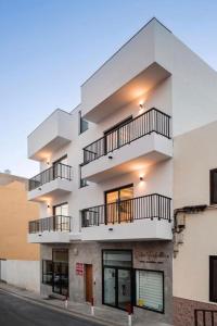 an apartment building with balconies on a street at La Cala de Alcalá Luxury in Alcalá