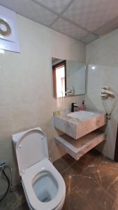 a bathroom with a white toilet and a sink at Taj Wadi Rum camp in Wadi Rum