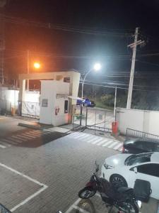 a car parked next to a gas station at night at Juhh Bella Condomínio in Botucatu